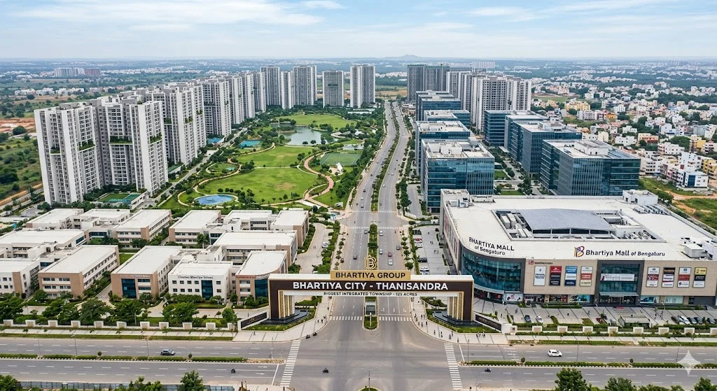 Aerial view of Bhartiya City, the largest integrated residential township on Thanisandra Main Road, featuring premium apartments, retail spaces, and IT parks.